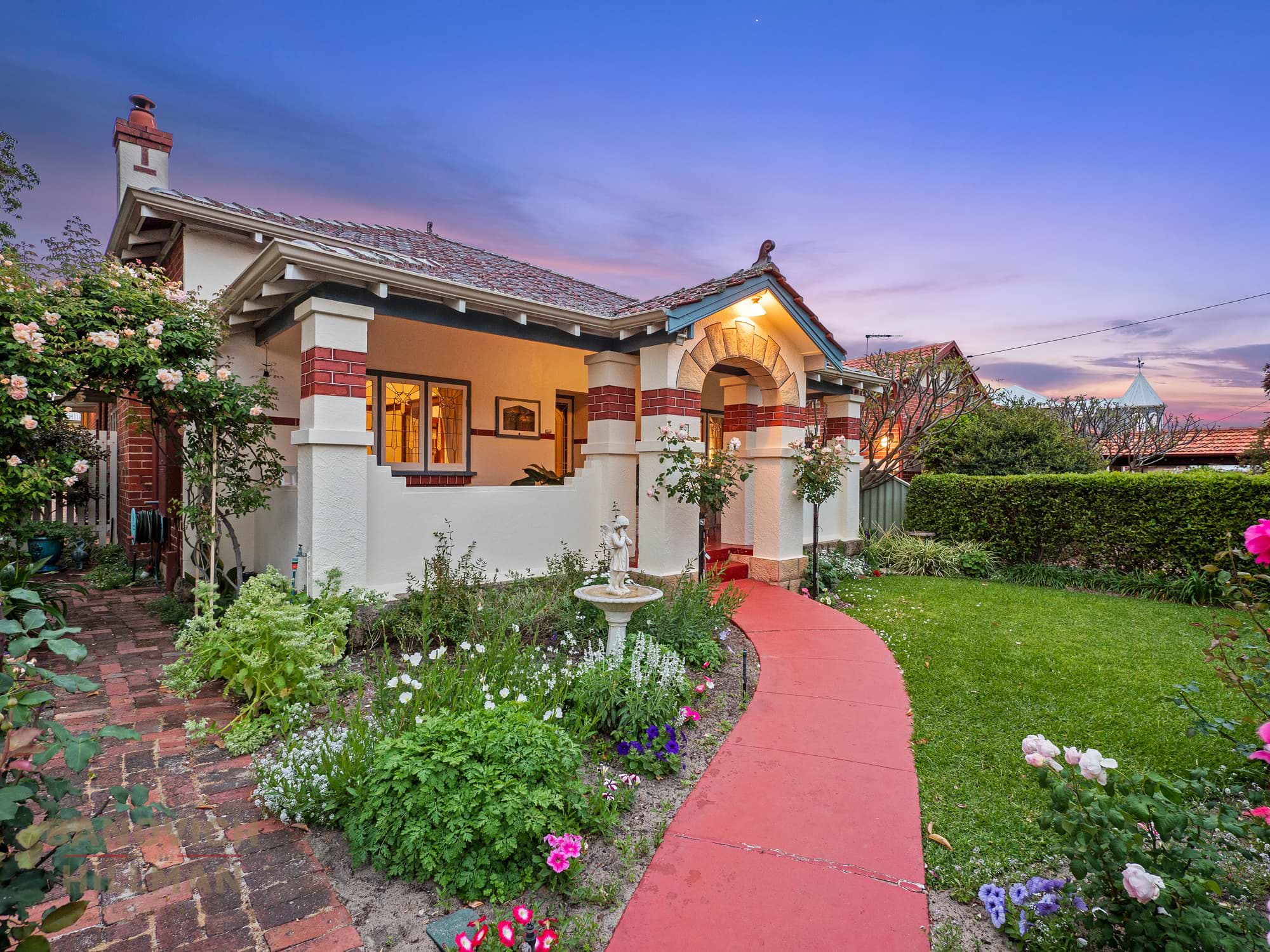 Front of Kensington, Perth property with brick road leading in.
